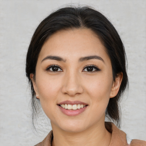 Joyful asian young-adult female with medium  brown hair and brown eyes