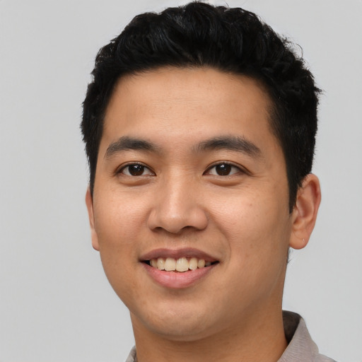 Joyful asian young-adult male with short  black hair and brown eyes