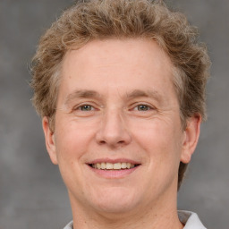 Joyful white adult male with short  brown hair and grey eyes