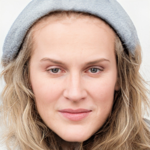 Joyful white young-adult female with long  brown hair and blue eyes