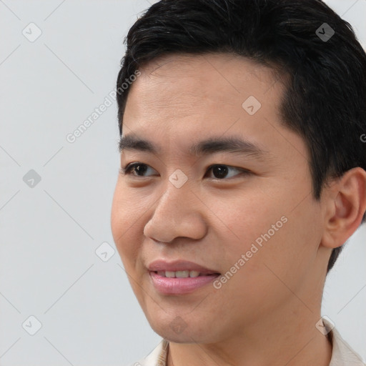 Joyful asian young-adult male with short  brown hair and brown eyes