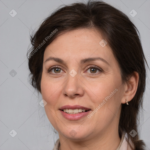 Joyful white adult female with medium  brown hair and brown eyes