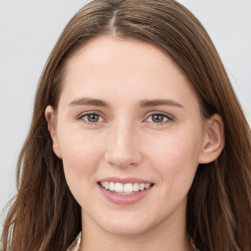 Joyful white young-adult female with long  brown hair and grey eyes