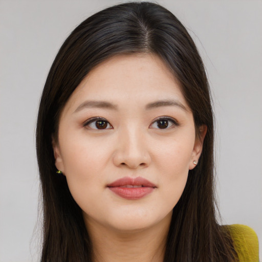 Joyful asian young-adult female with long  brown hair and brown eyes