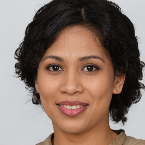 Joyful latino young-adult female with long  brown hair and brown eyes