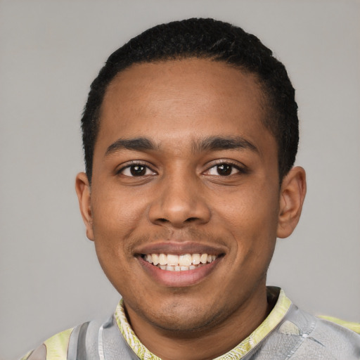Joyful black young-adult male with short  black hair and brown eyes