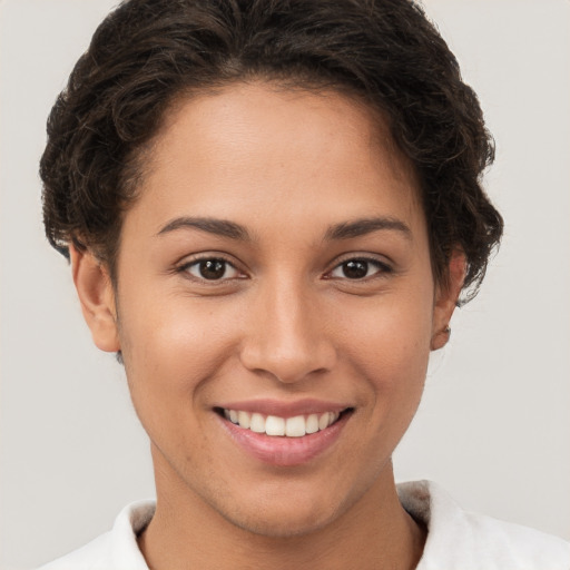 Joyful white young-adult female with short  brown hair and brown eyes