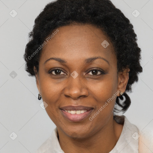 Joyful black adult female with short  black hair and brown eyes