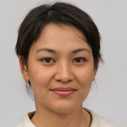 Joyful asian young-adult female with short  brown hair and brown eyes