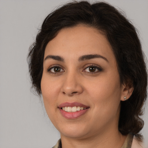 Joyful white young-adult female with medium  brown hair and brown eyes