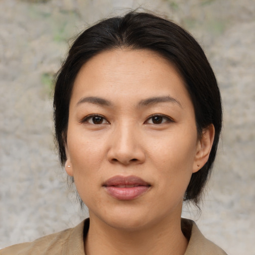 Joyful asian young-adult female with medium  brown hair and brown eyes