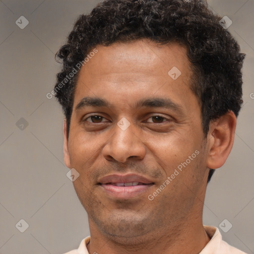 Joyful black adult male with short  brown hair and brown eyes