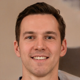 Joyful white young-adult male with short  brown hair and brown eyes