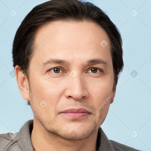 Joyful white adult male with short  brown hair and brown eyes