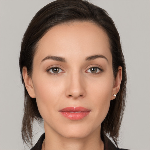 Joyful white young-adult female with long  brown hair and brown eyes