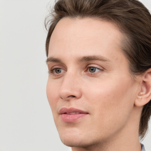 Joyful white young-adult male with medium  brown hair and grey eyes