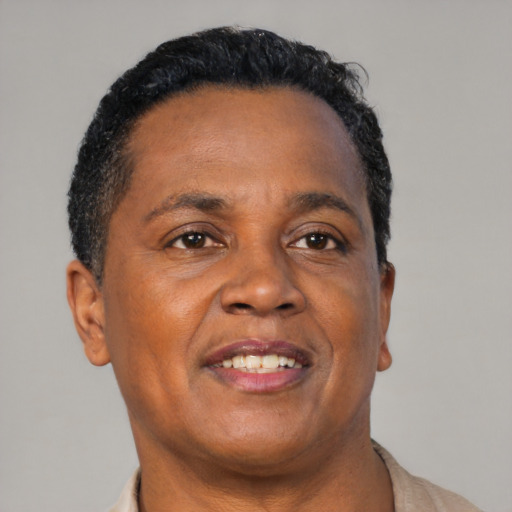 Joyful black adult male with short  brown hair and brown eyes