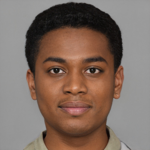 Joyful black young-adult male with short  brown hair and brown eyes