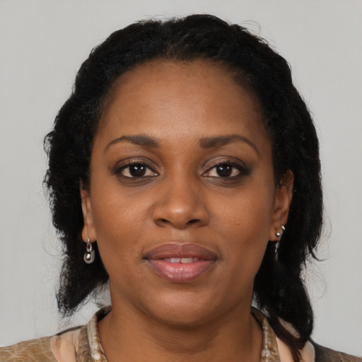 Joyful black adult female with medium  brown hair and brown eyes