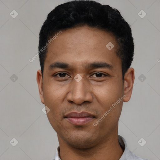 Joyful latino young-adult male with short  black hair and brown eyes