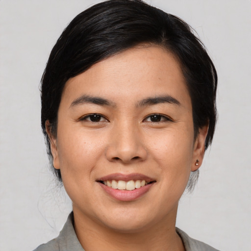 Joyful asian young-adult female with medium  black hair and brown eyes