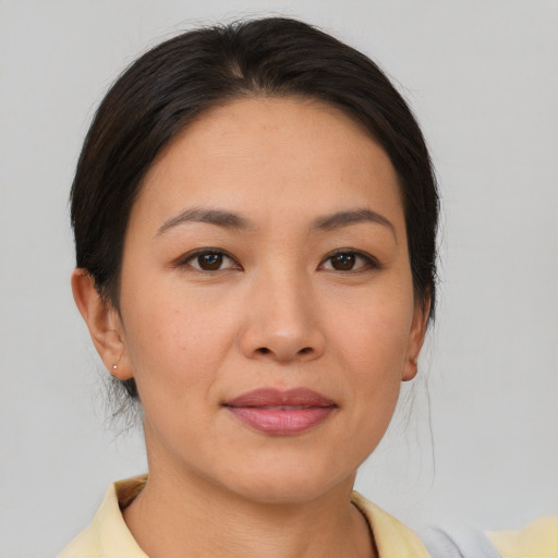 Joyful asian young-adult female with short  brown hair and brown eyes