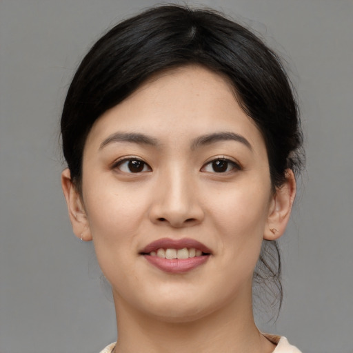 Joyful asian young-adult female with medium  black hair and brown eyes