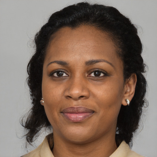 Joyful black adult female with medium  black hair and brown eyes