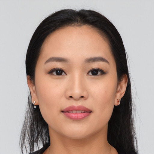 Joyful asian young-adult female with long  brown hair and brown eyes