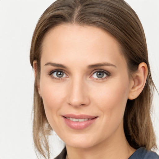 Joyful white young-adult female with long  brown hair and grey eyes