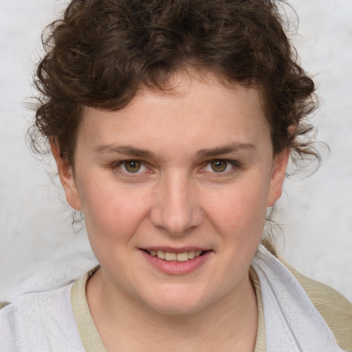 Joyful white young-adult female with medium  brown hair and blue eyes