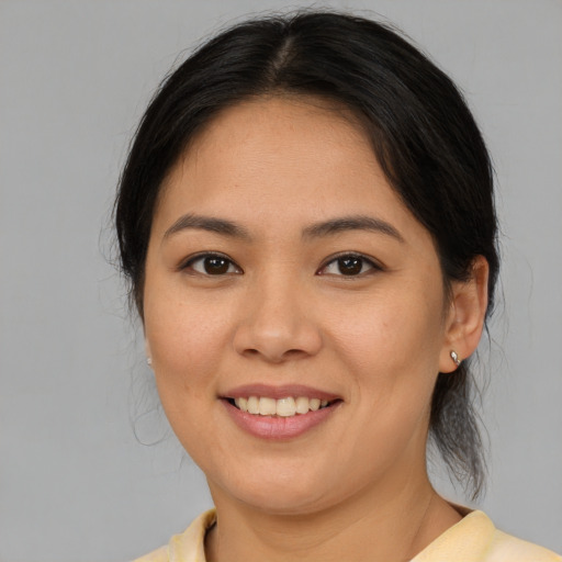 Joyful asian young-adult female with medium  brown hair and brown eyes