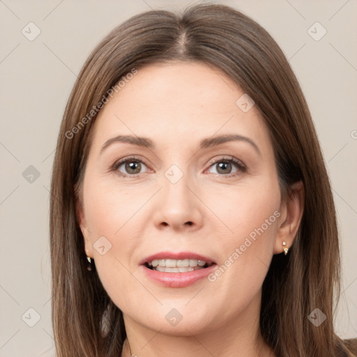 Joyful white adult female with long  brown hair and brown eyes