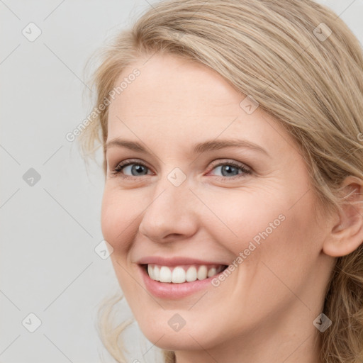 Joyful white young-adult female with long  brown hair and blue eyes