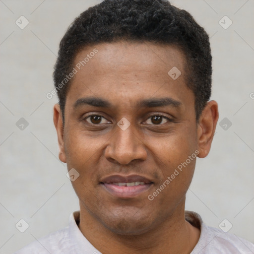 Joyful black young-adult male with short  black hair and brown eyes