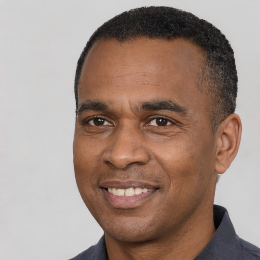 Joyful latino adult male with short  black hair and brown eyes