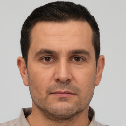 Neutral white adult male with short  black hair and brown eyes