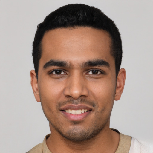 Joyful latino young-adult male with short  black hair and brown eyes