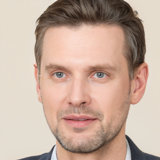 Joyful white adult male with short  brown hair and grey eyes