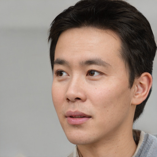 Neutral asian young-adult male with short  brown hair and brown eyes