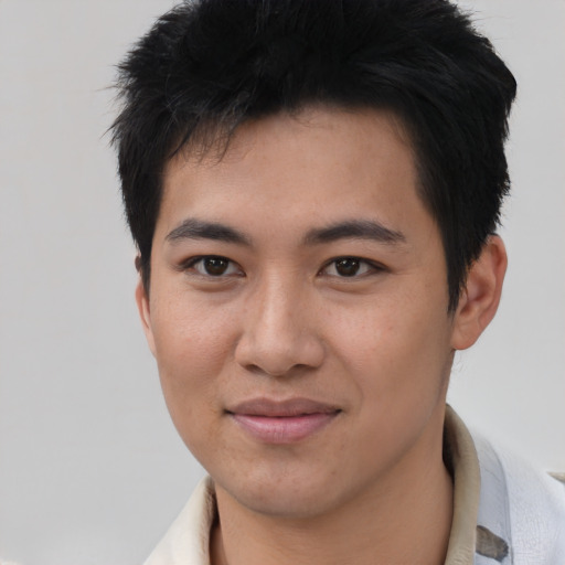 Joyful asian young-adult male with short  black hair and brown eyes