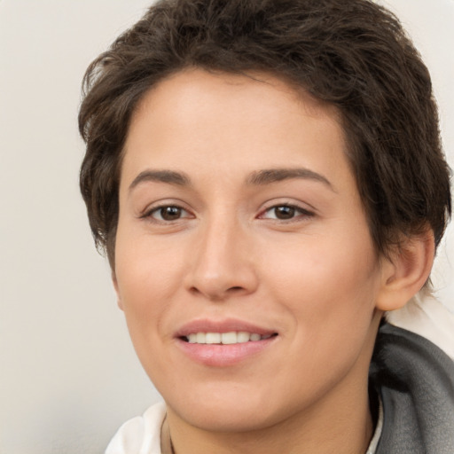 Joyful white young-adult female with short  brown hair and brown eyes