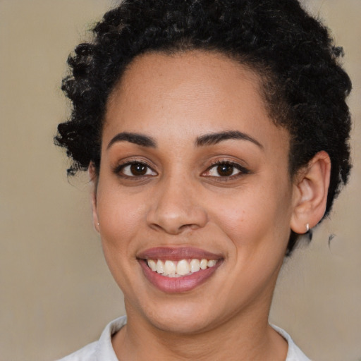 Joyful latino young-adult female with short  brown hair and brown eyes