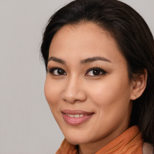 Joyful asian young-adult female with long  brown hair and brown eyes
