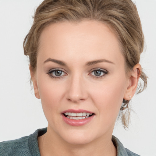 Joyful white young-adult female with medium  brown hair and blue eyes