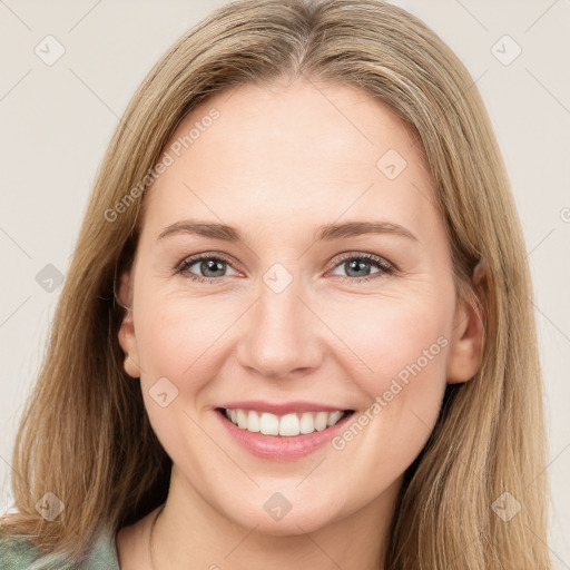 Joyful white young-adult female with long  brown hair and green eyes