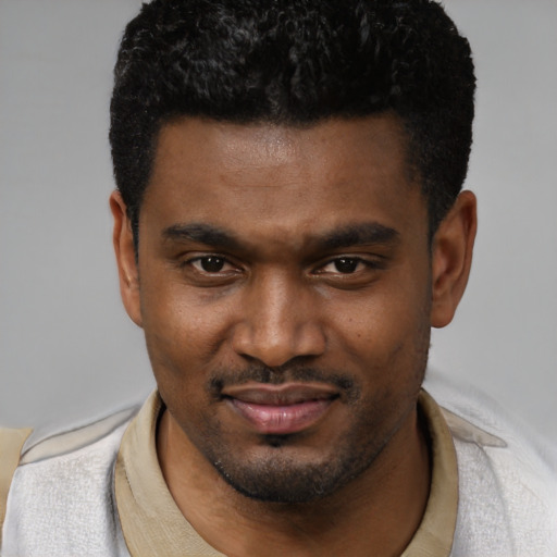 Joyful latino young-adult male with short  black hair and brown eyes