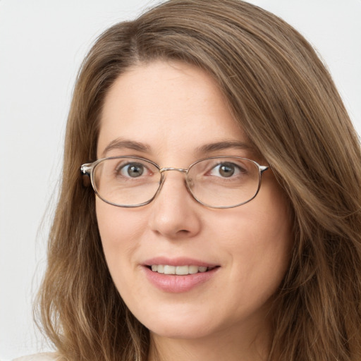 Joyful white young-adult female with long  brown hair and green eyes