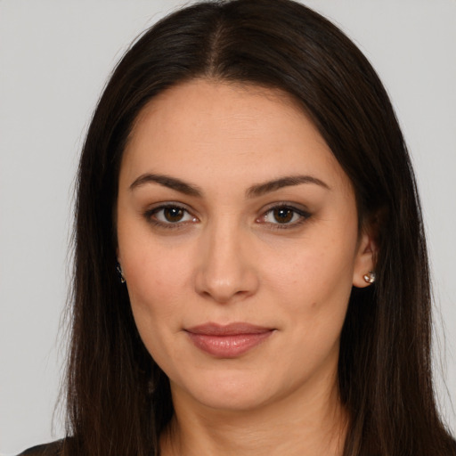 Joyful white young-adult female with long  brown hair and brown eyes