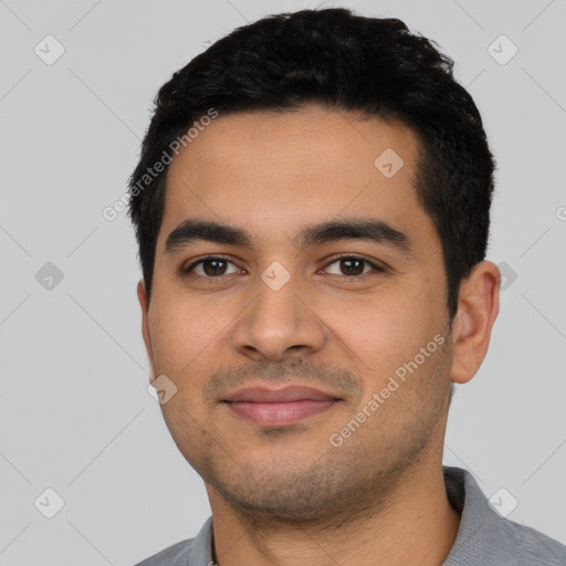 Joyful latino young-adult male with short  black hair and brown eyes